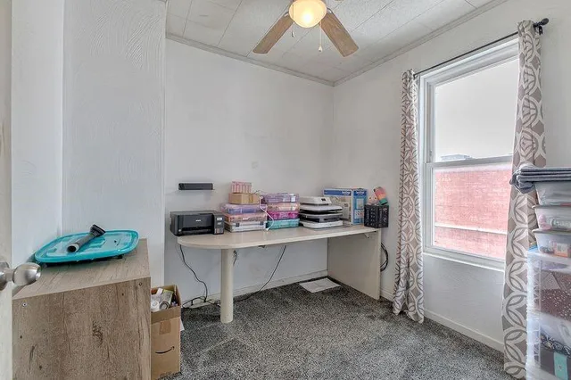 a work room with furniture and a window