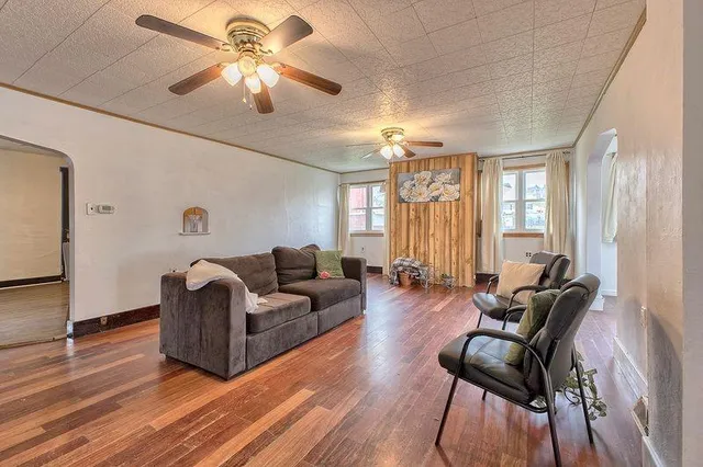 a living room with furniture and wooden floor