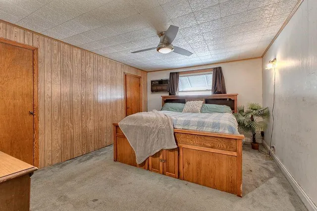 a room with a bed and a dresser in it