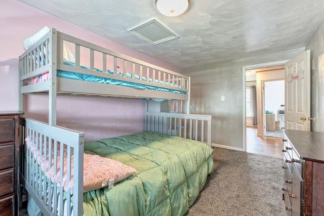 a bedroom with a bed and a baby crib
