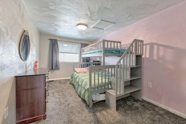 a bedroom with furniture and a large window