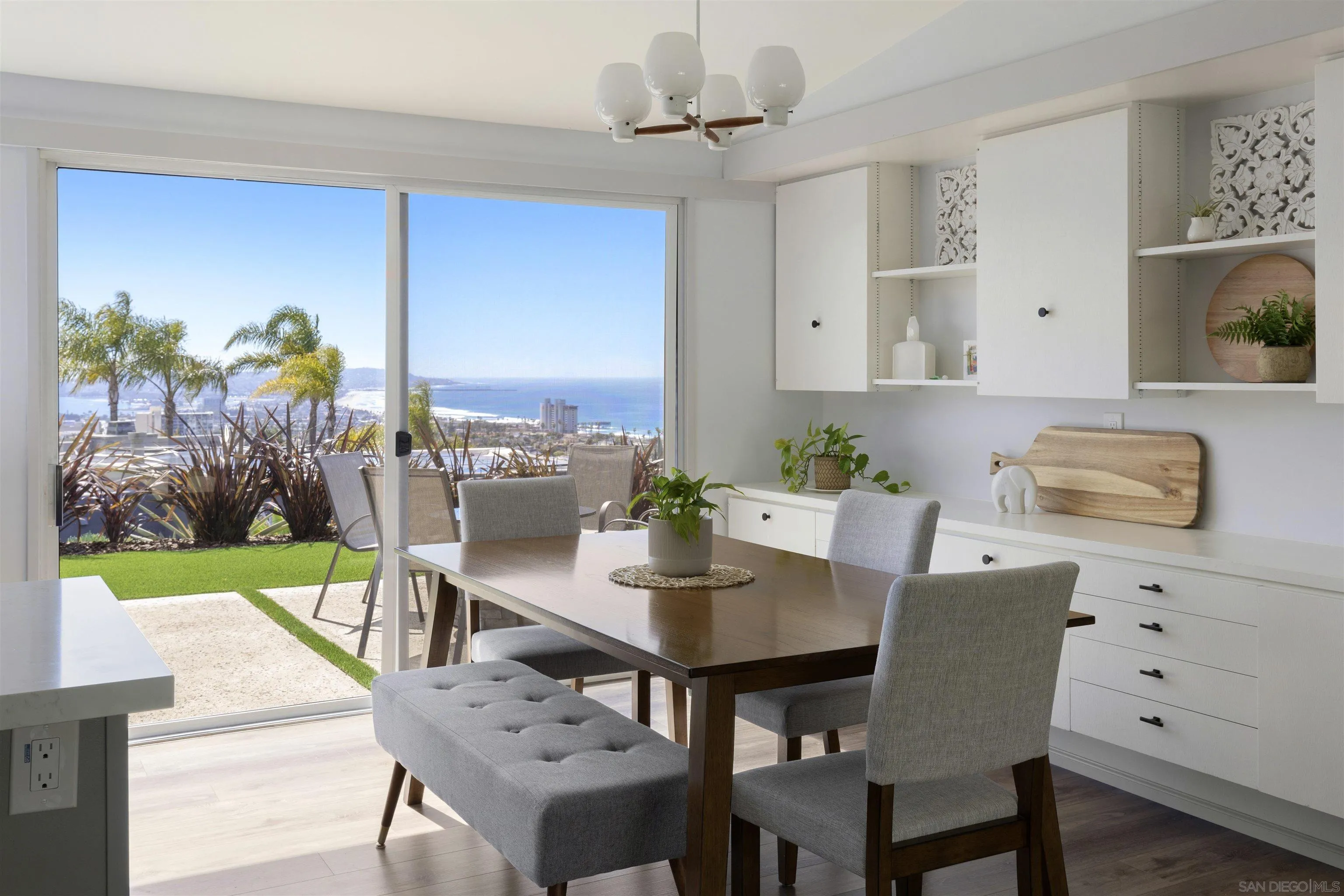 5502 Rutgers Road La Jolla, CA 92037 - Photo 11 of 28 a view of a dining room with furniture and a floor to ceiling window