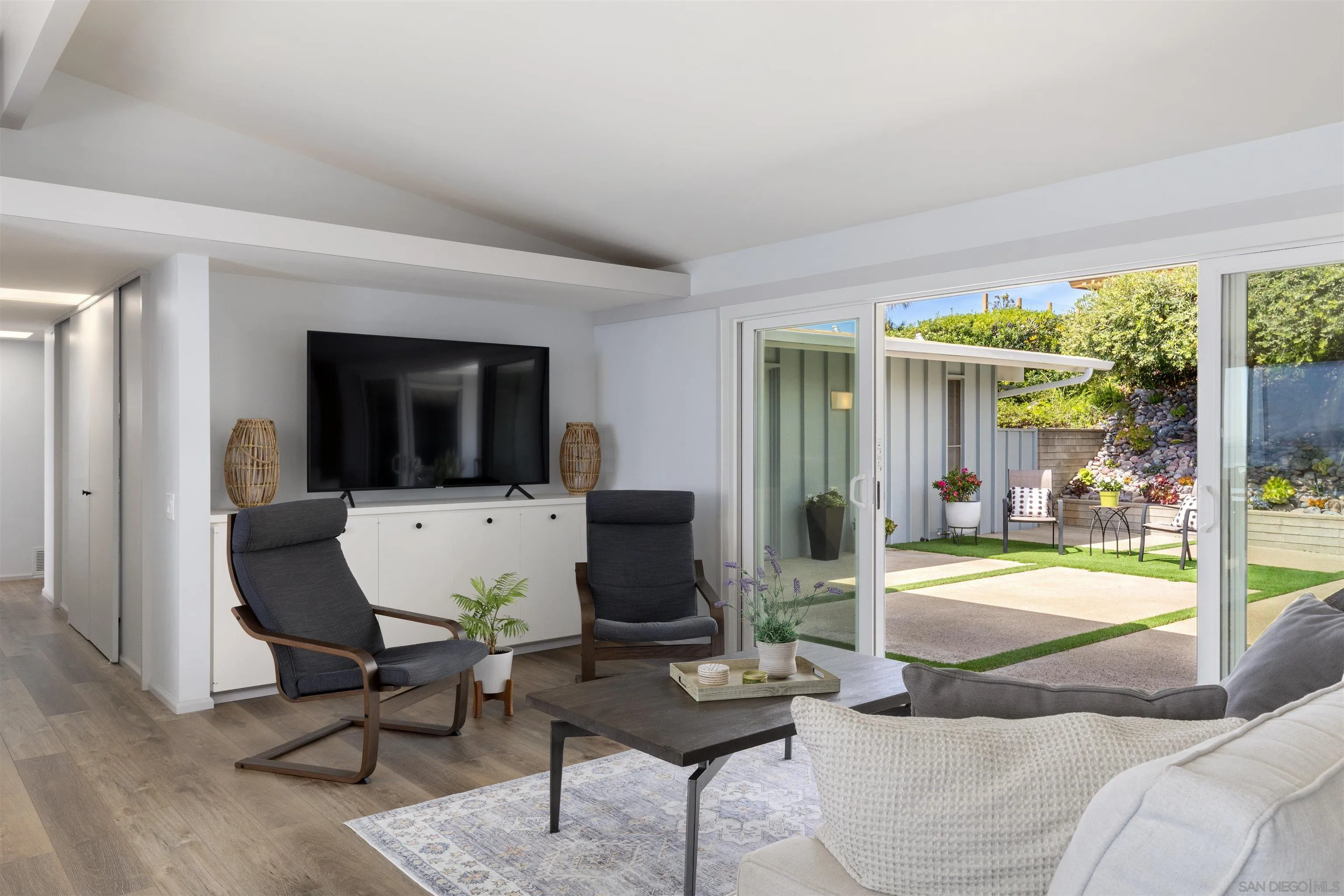 5502 Rutgers Road La Jolla, CA 92037 - Photo 13 of 28 a living room with furniture and a flat screen tv