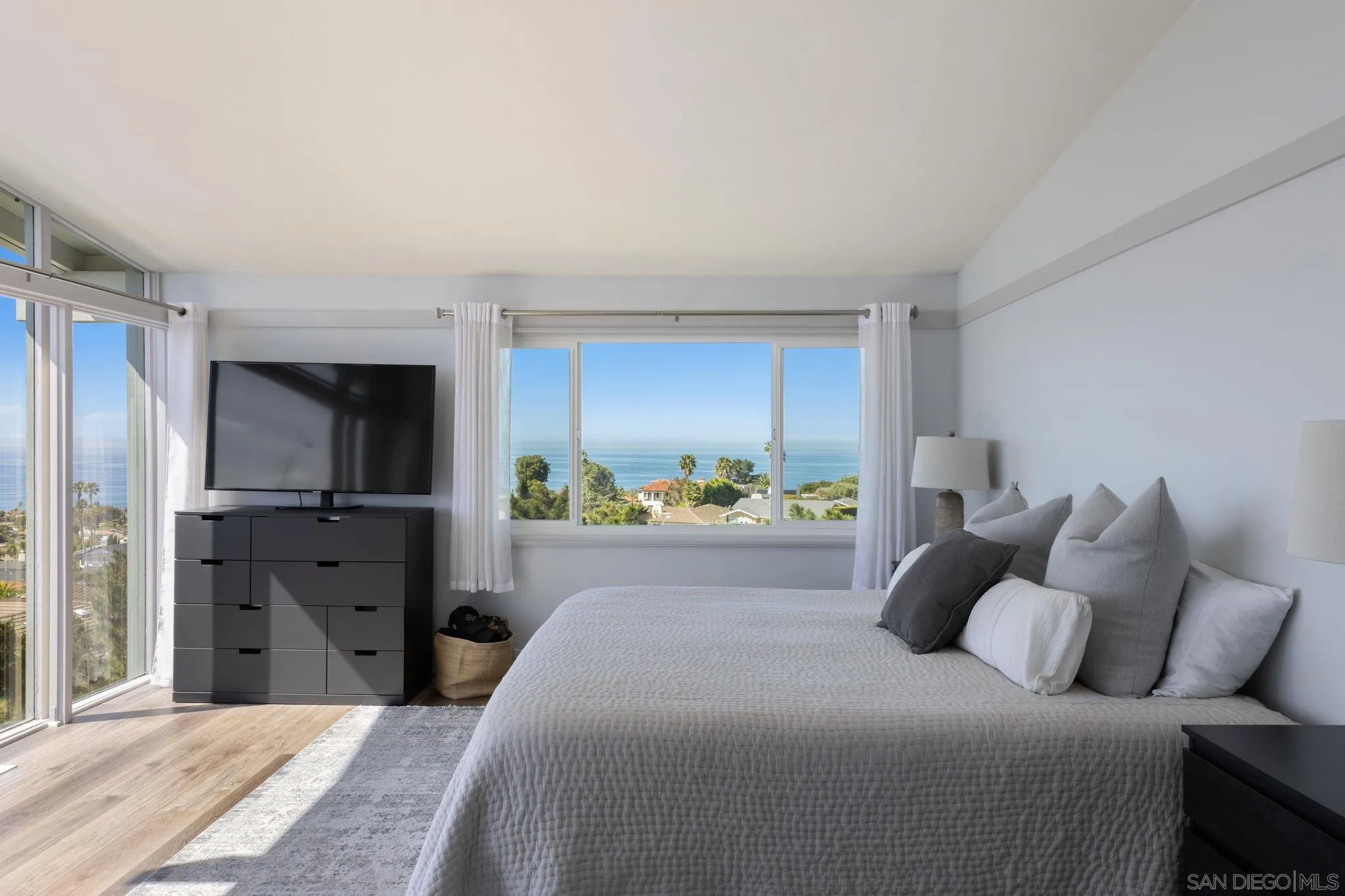 5502 Rutgers Road La Jolla, CA 92037 - Photo 15 of 28 a large bedroom with a bed and a window