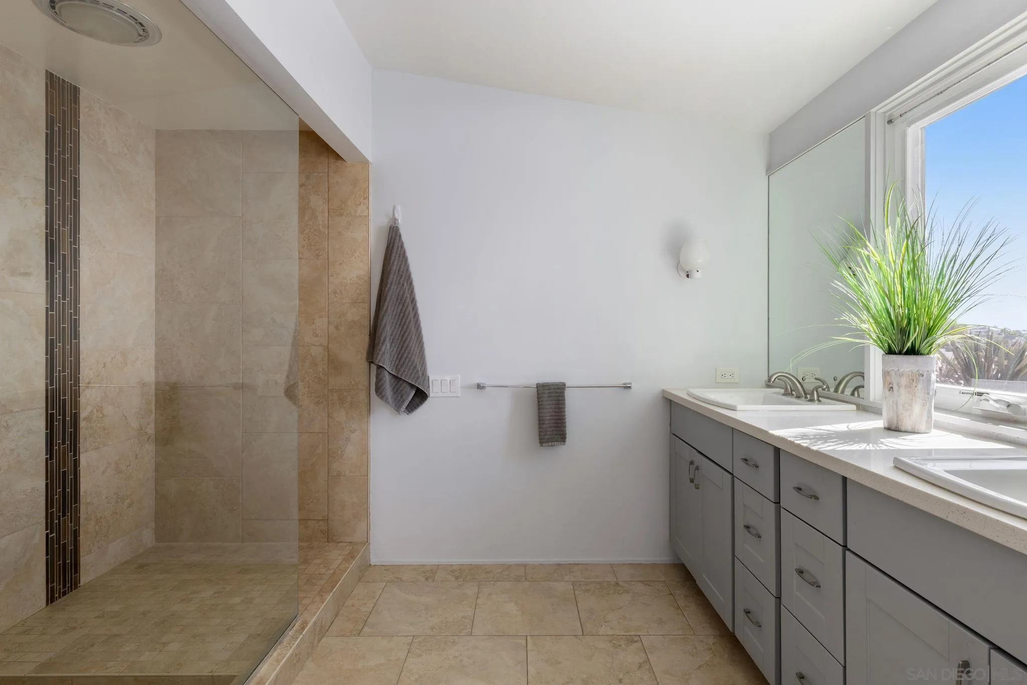 5502 Rutgers Road La Jolla, CA 92037 - Photo 16 of 28 a bathroom with a granite countertop sink a mirror and a shower