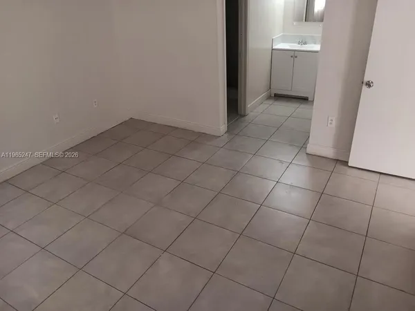 a white refrigerator freezer and a stove sitting inside of a kitchen
