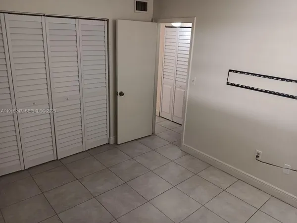 a view of backyard with swimming pool and seating space