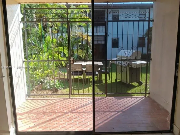 a kitchen with stainless steel appliances granite countertop a stove a sink and white cabinets