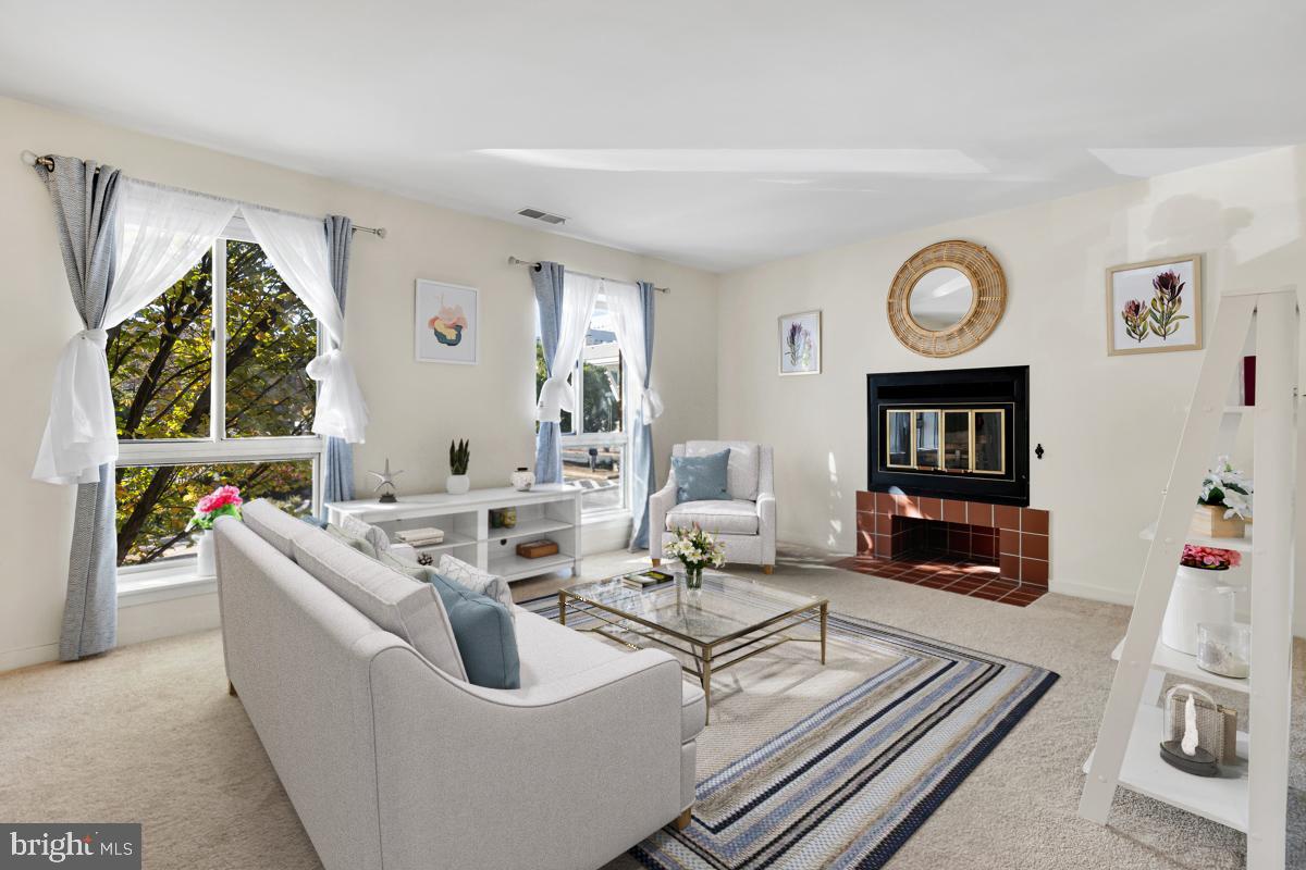 403 South Sharp Street, Unit R 2 Baltimore, MD 21201 - Photo 1 of 15 a living room with furniture a large window and a fireplace