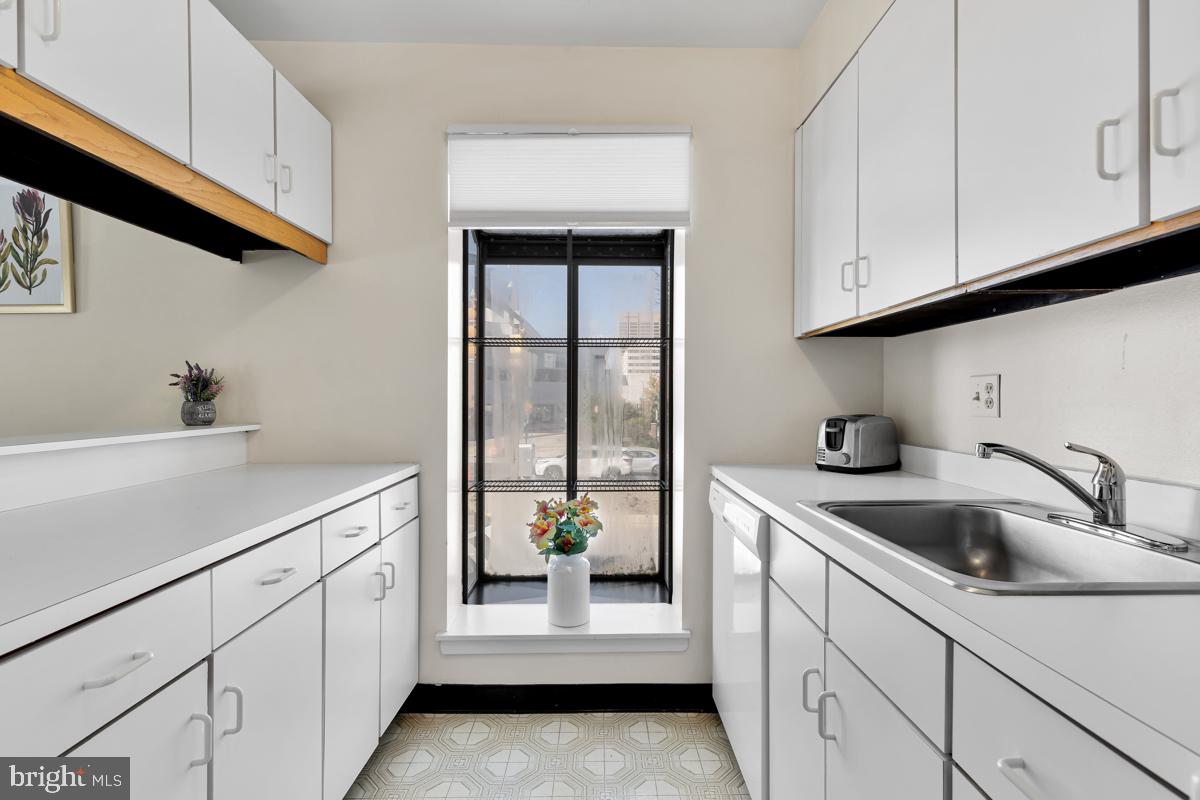 403 South Sharp Street, Unit R 2 Baltimore, MD 21201 - Photo 11 of 15 a kitchen with white cabinets a sink and dishwasher