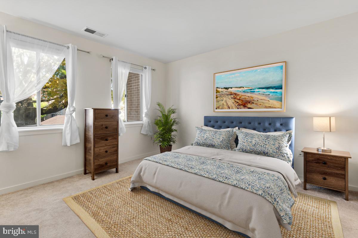 403 South Sharp Street, Unit R 2 Baltimore, MD 21201 - Photo 4 of 15 a bedroom with a large bed and a painting on the wall