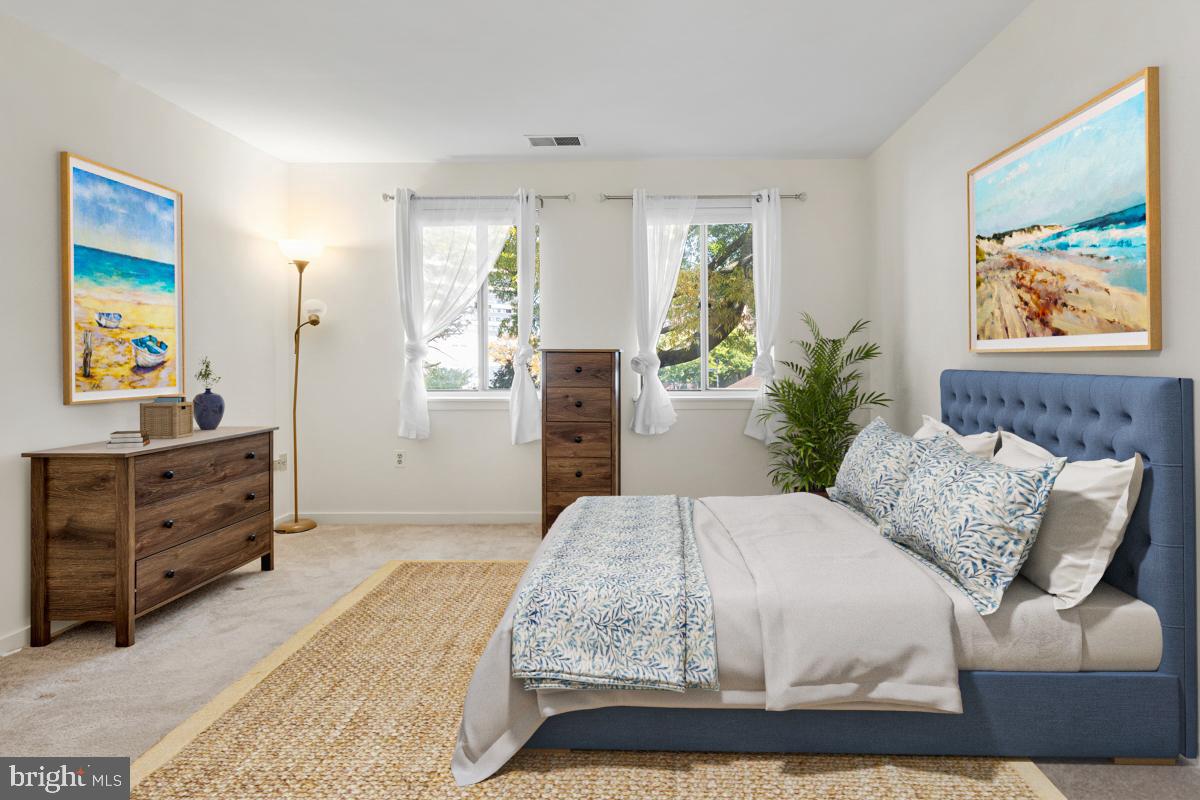 403 South Sharp Street, Unit R 2 Baltimore, MD 21201 - Photo 5 of 15 a bedroom with a bed and painting on the wall