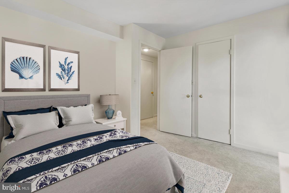 403 South Sharp Street, Unit R 2 Baltimore, MD 21201 - Photo 8 of 15 a spacious bedroom with a bed and a couch