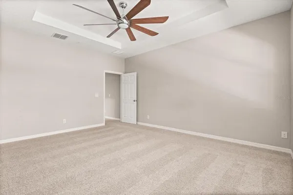 an empty room with a fan and a fan