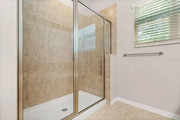 a bathroom with a glass shower door
