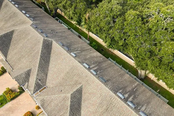 an aerial view of residential building with parking