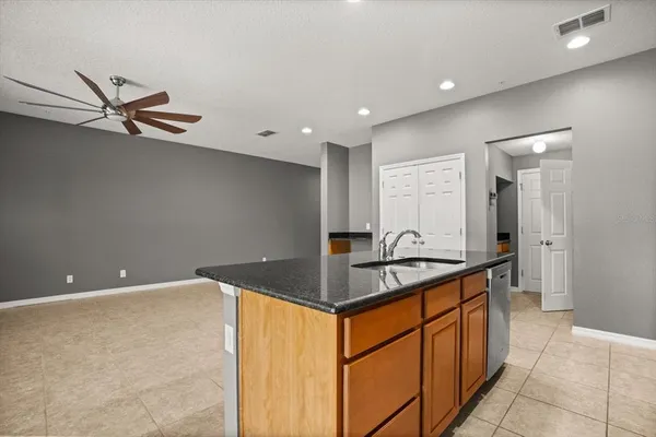 a kitchen with stainless steel appliances granite countertop a sink and a stove