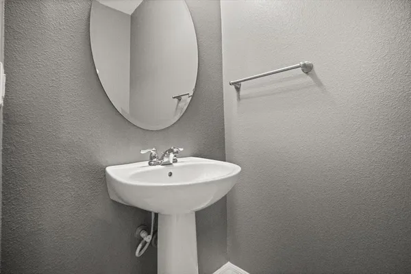 a bathroom with a sink a mirror and a shower