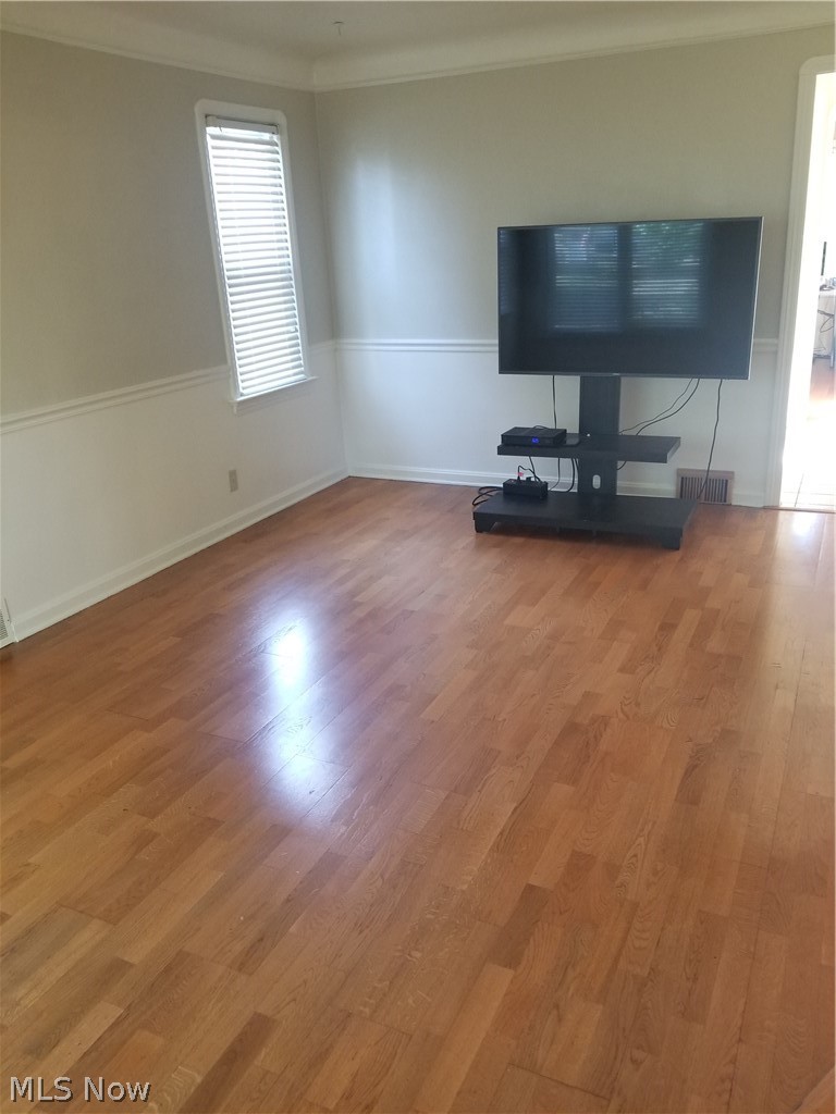 4002 Redfern Road Parma, OH 44134 - Photo 10 of 26 Living room is bright and features a wood floor and chair rail for an added touch!