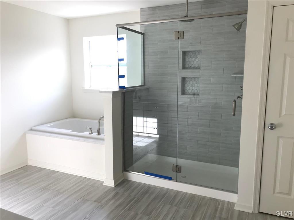 309 Aubrey Road, Unit 18 Nazareth, PA 18064 - Photo 11 of 13 a bathroom with a shower a mirror and a shower
