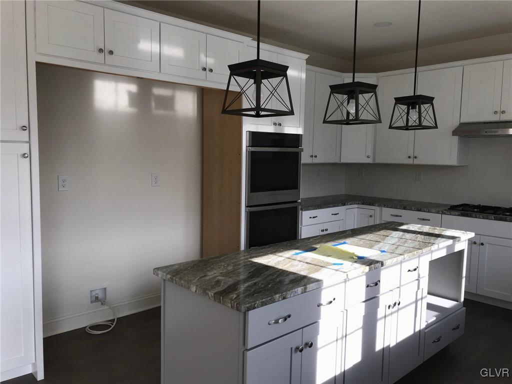 309 Aubrey Road, Unit 18 Nazareth, PA 18064 - Photo 7 of 13 a kitchen with stainless steel appliances granite countertop a sink a stove and a refrigerator