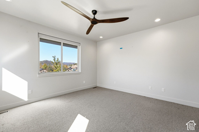 1067 Station Loop Road Park City, UT 84098 - Photo 26 of 38 Recessed lighting, ceiling fan with wood-finish blades, and a large window with roller shades