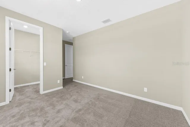 a view of an empty room and closet area