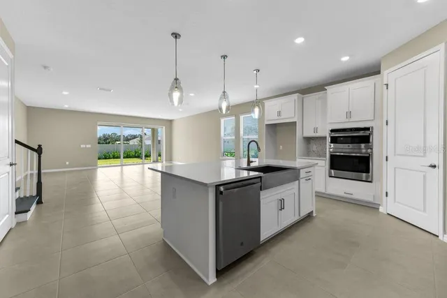 a kitchen with stainless steel appliances granite countertop a stove and a refrigerator