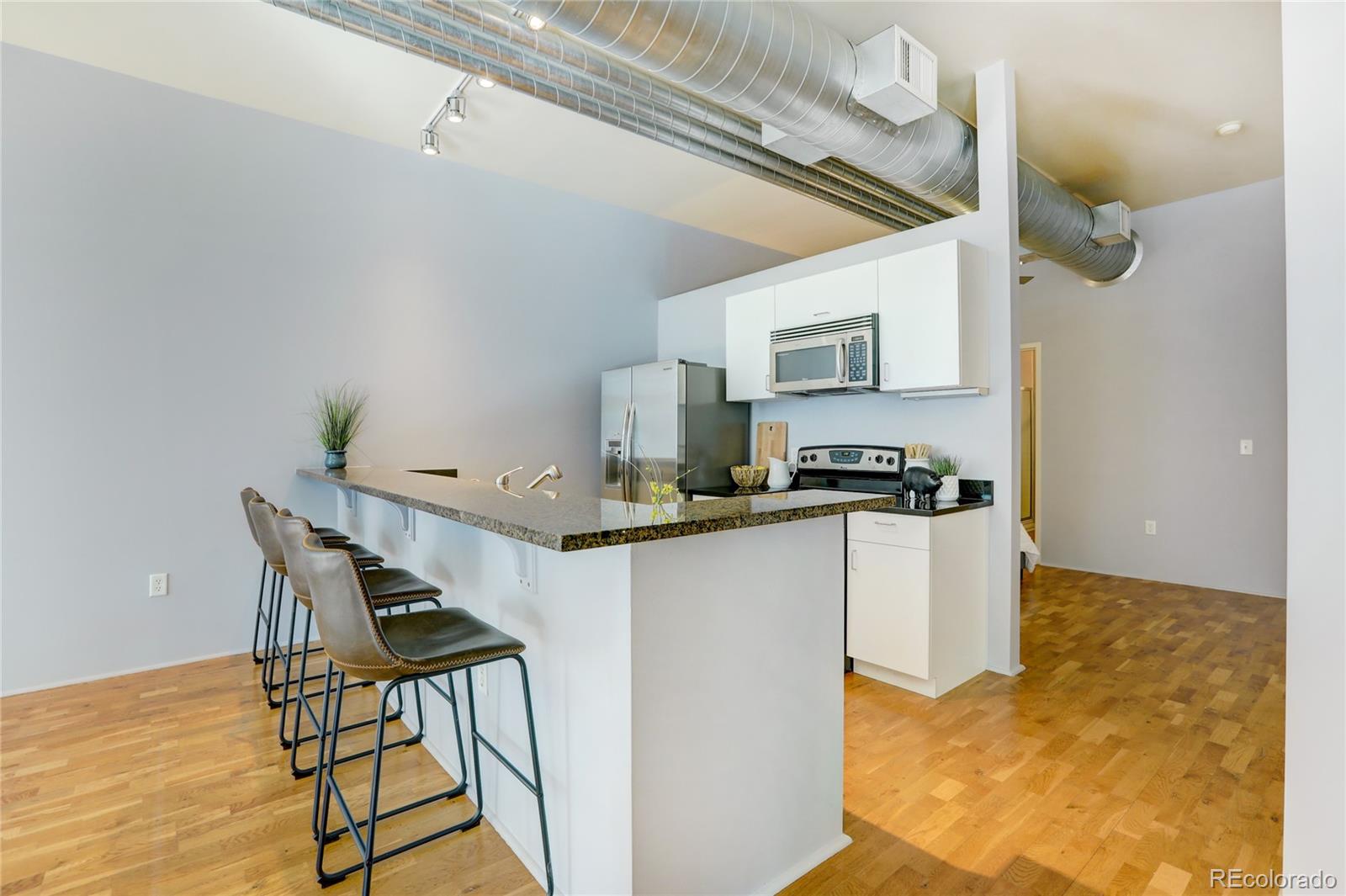 3100 Huron Street, Unit 2R Denver, CO 80202 - Photo 21 of 33 a kitchen with a table and chairs in it