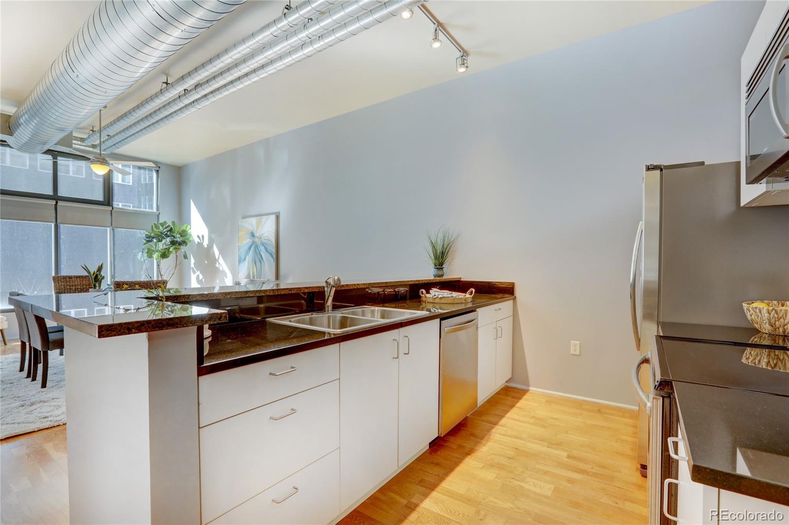 3100 Huron Street, Unit 2R Denver, CO 80202 - Photo 23 of 33 a kitchen with granite countertop a sink and cabinets