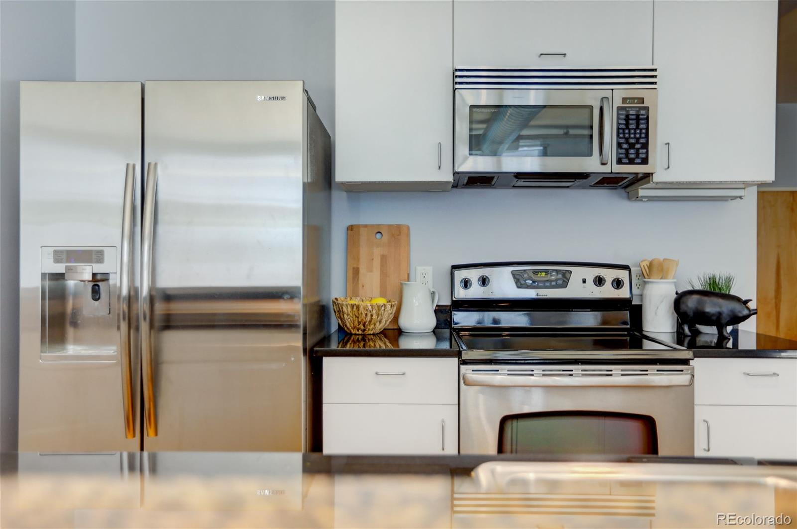 3100 Huron Street, Unit 2R Denver, CO 80202 - Photo 25 of 33 a kitchen with cabinets and steel stainless steel appliances