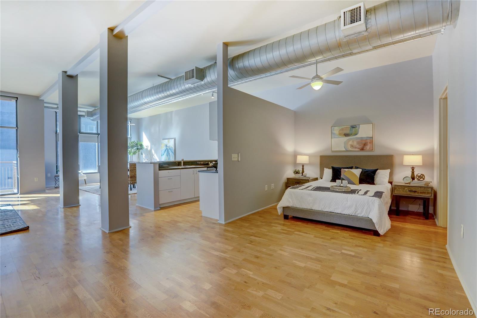 3100 Huron Street, Unit 2R Denver, CO 80202 - Photo 3 of 33 a spacious bedroom with a bed and dresser with wooden floor