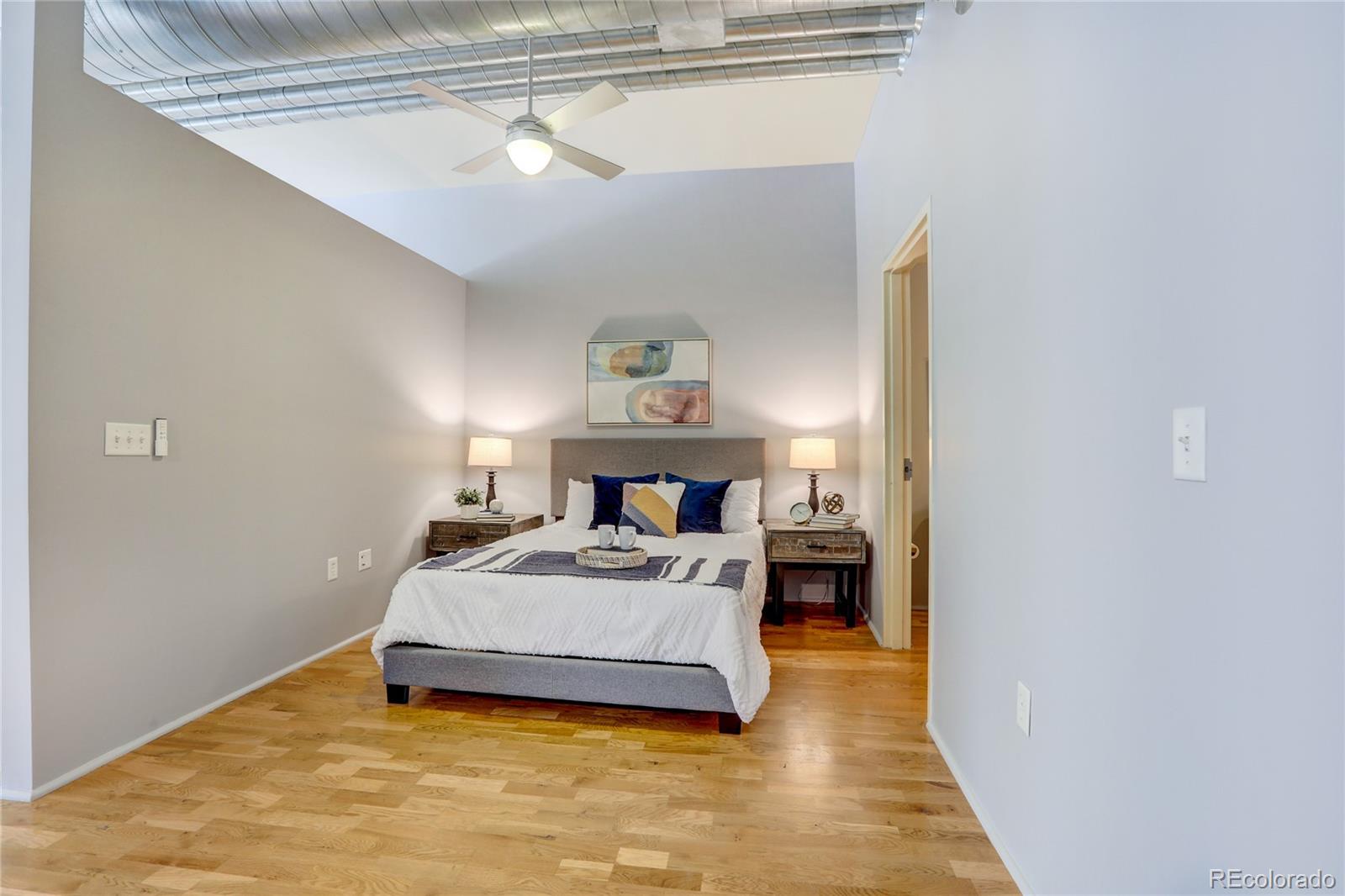3100 Huron Street, Unit 2R Denver, CO 80202 - Photo 6 of 33 a bedroom with a bed and a lamp on table