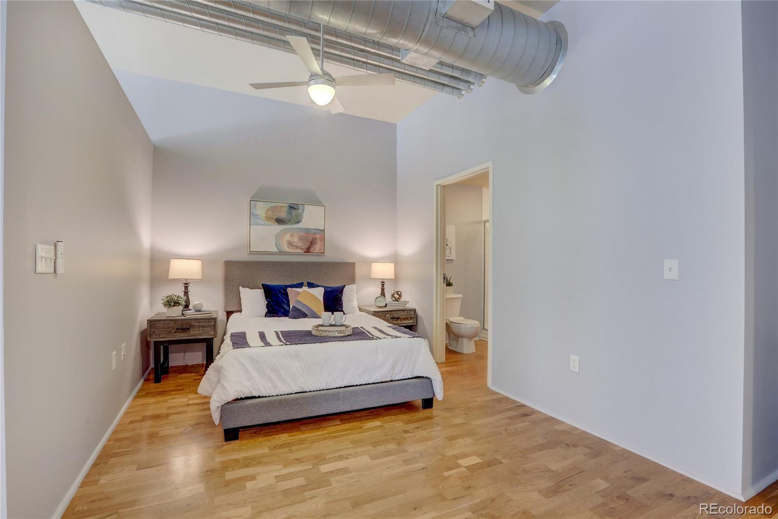3100 Huron Street, Unit 2R Denver, CO 80202 - Photo 7 of 33 a bedroom with a bed and a chandelier