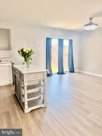 a view of a room with wooden floor and cabinet