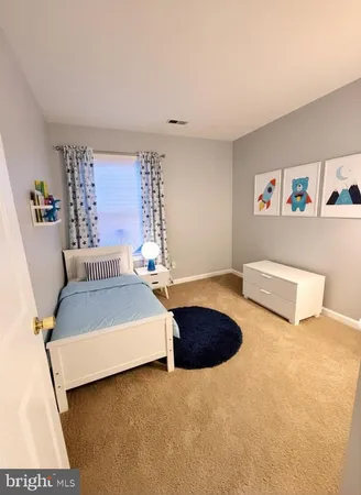 a bedroom with a bed and a couch