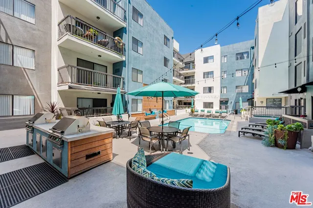 a building outdoor space with patio furniture and potted plants