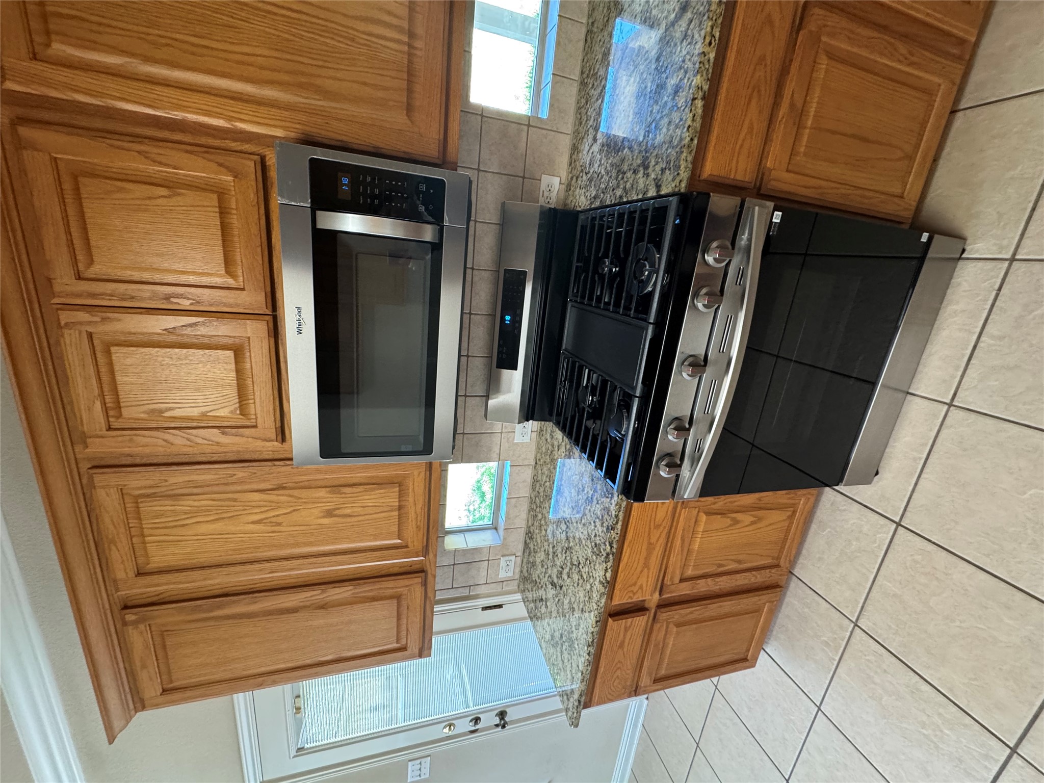 2204 Voyageurs Lane Austin, TX 78747 - Photo 6 of 29 a kitchen with granite countertop a stove top oven cabinetry a sink and a window