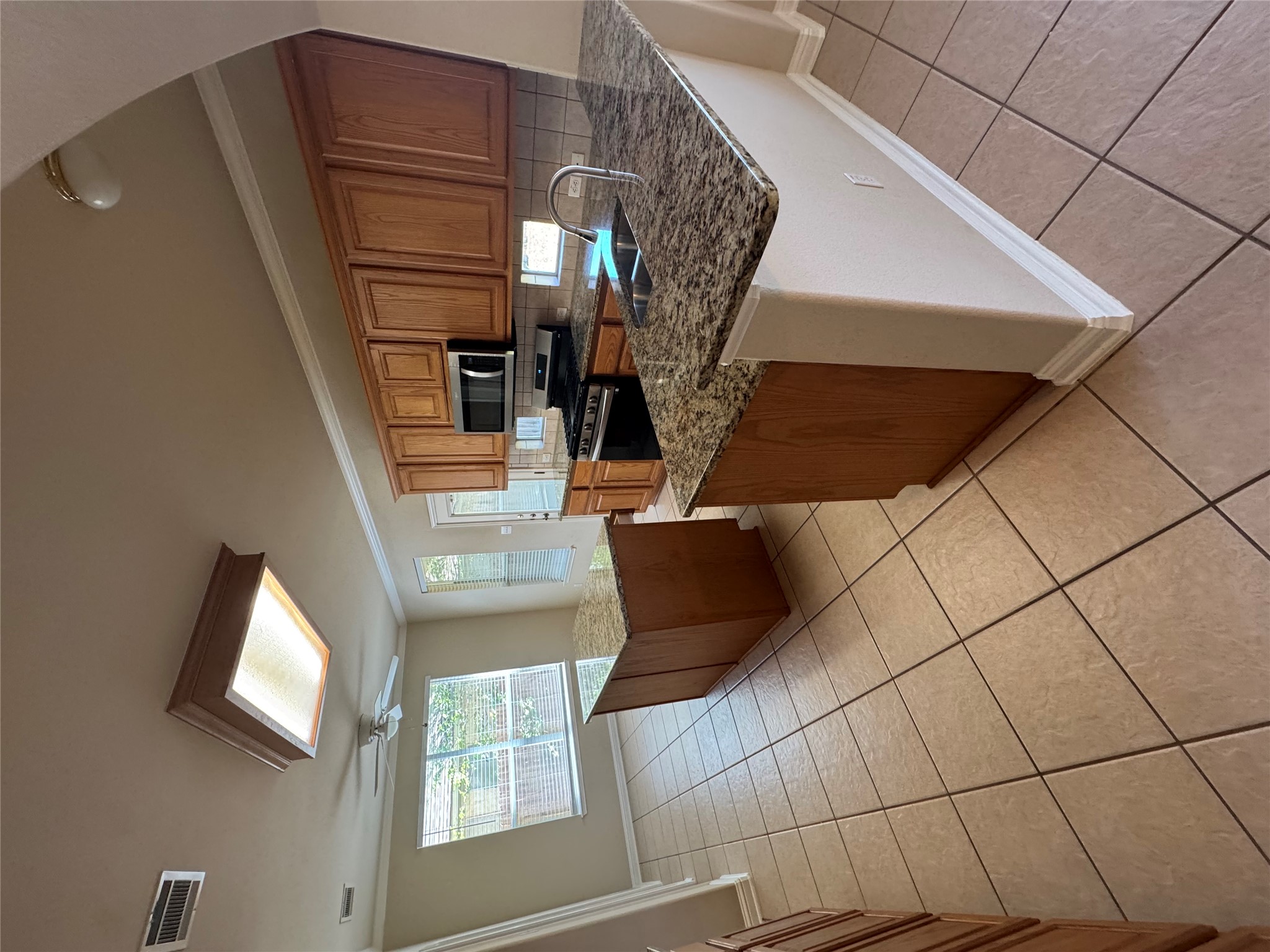 2204 Voyageurs Lane Austin, TX 78747 - Photo 7 of 29 a kitchen with kitchen island granite countertop a sink and a stove top oven