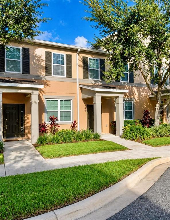 8253 Maritime Flag Street, Unit 109 Windermere, FL 34786 - Photo 1 of 23 front view of a brick house with a yard