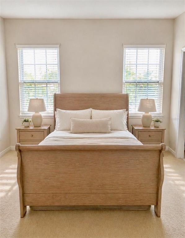 8253 Maritime Flag Street, Unit 109 Windermere, FL 34786 - Photo 14 of 23 a bed sitting in a bedroom next to a window