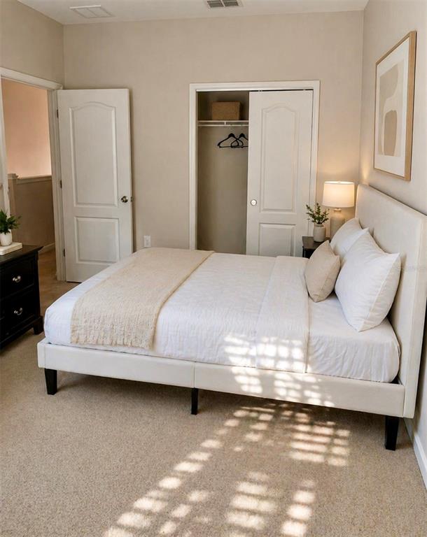 8253 Maritime Flag Street, Unit 109 Windermere, FL 34786 - Photo 15 of 23 a bedroom with a bed and a night stand