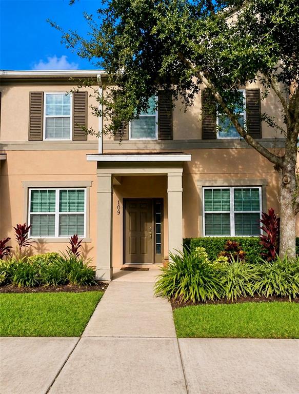 8253 Maritime Flag Street, Unit 109 Windermere, FL 34786 - Photo 2 of 23 front view of a house with a small yard