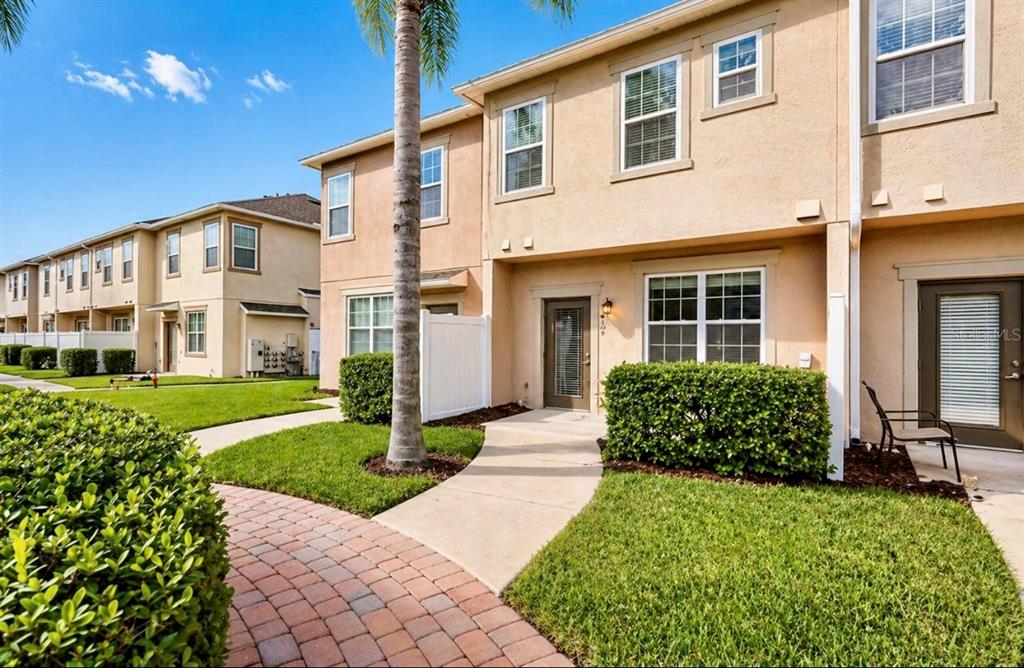8253 Maritime Flag Street, Unit 109 Windermere, FL 34786 - Photo 5 of 23 a front view of a house with a yard