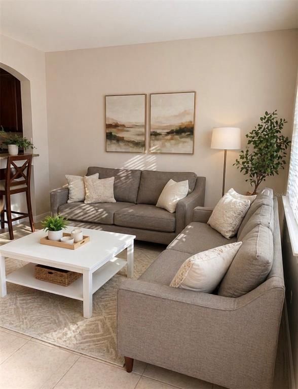8253 Maritime Flag Street, Unit 109 Windermere, FL 34786 - Photo 9 of 23 a living room with furniture and a flat screen tv