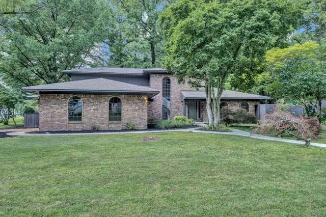 a front view of a house with a garden