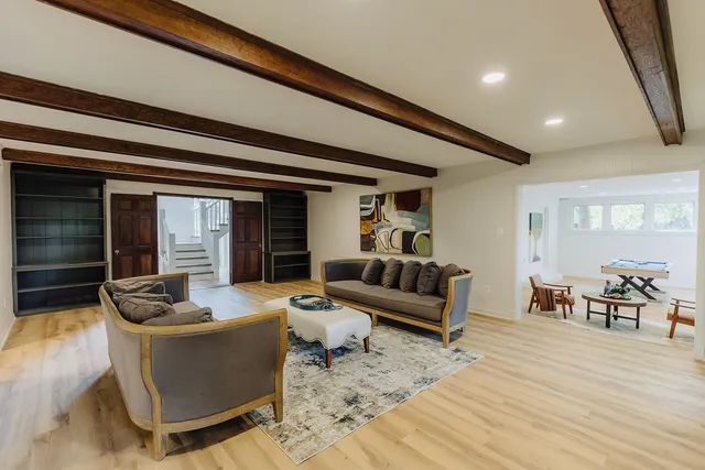 a living room with furniture and a wooden floor