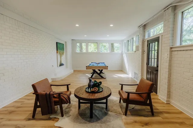 a view of a dining room with furniture and wooden floor