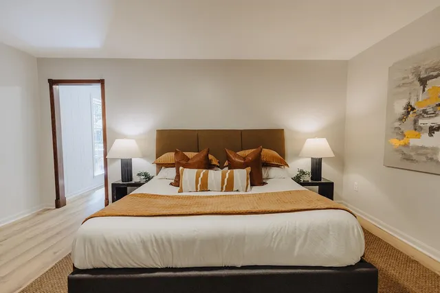 a bedroom with a bed and lamps