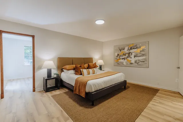 a bedroom with bed and a night stand